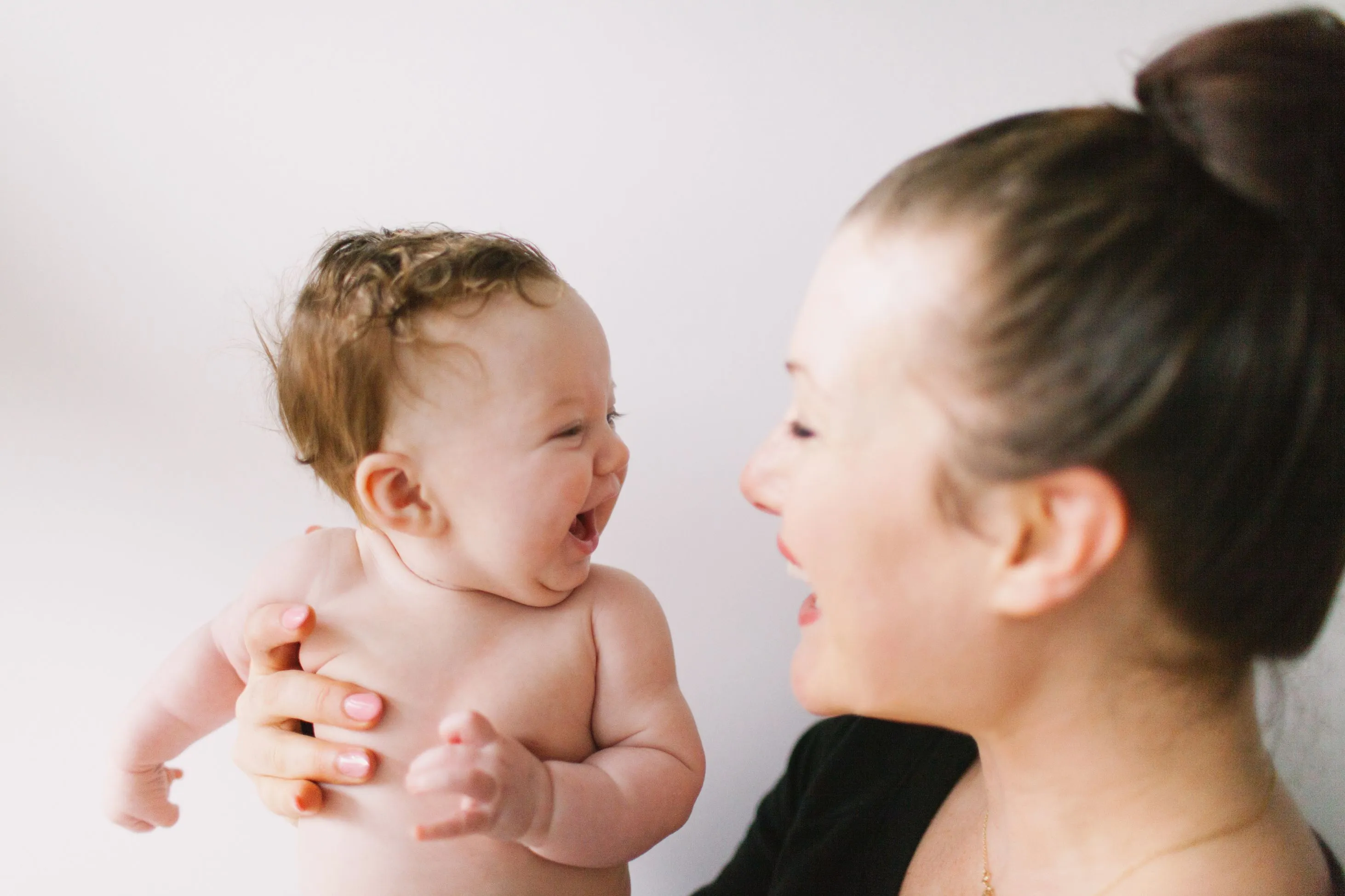 Laughing mother with newborn baby