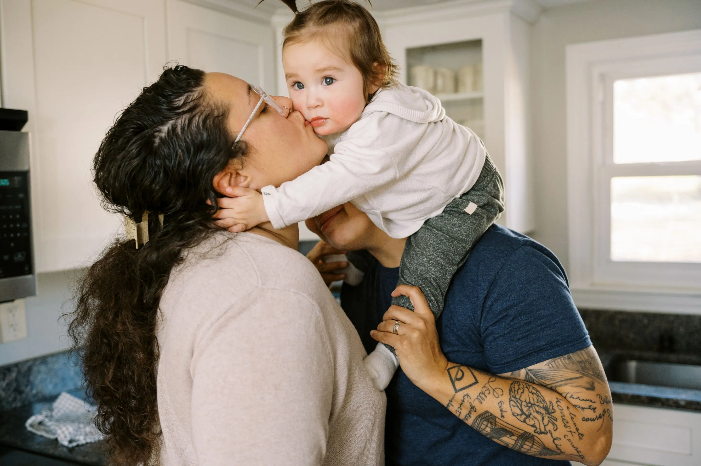 Mother kissing child