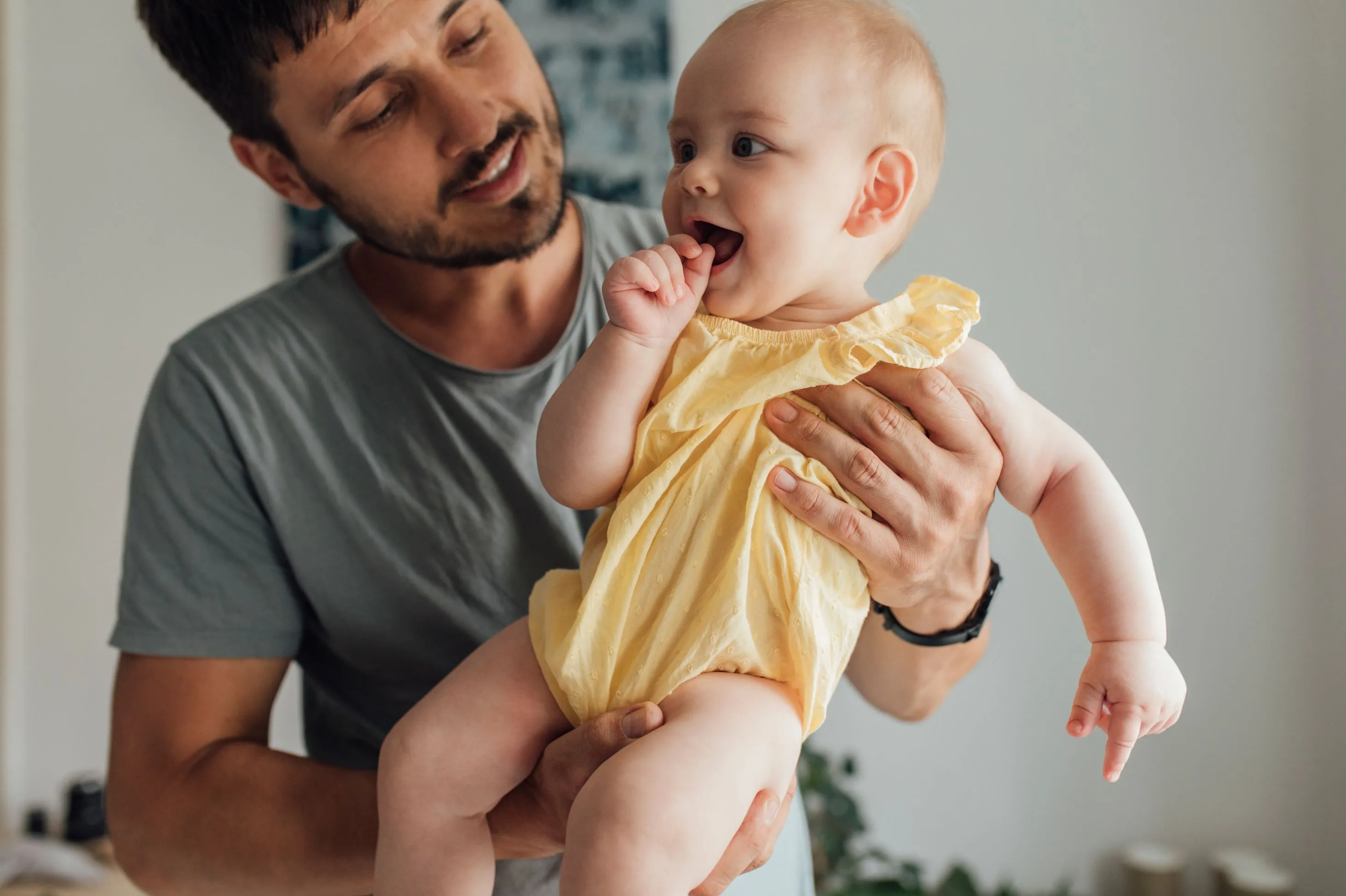 A father holding his baby daughter.