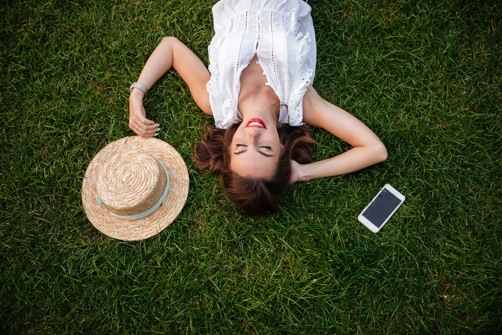 woman relaxing on the grass taking the stress out of infertility treatments